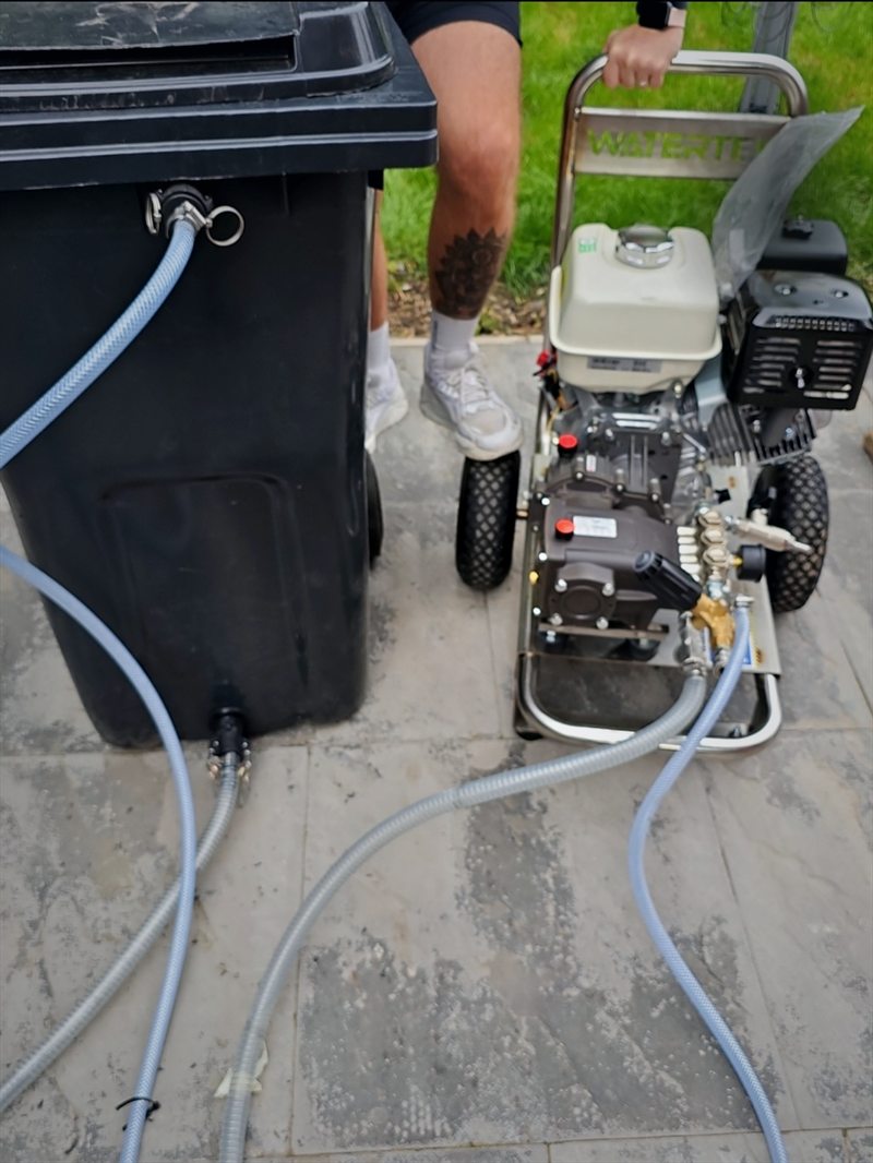 Morgan & Walker's Honda GX390 pressure washer set up on a patio, fed from a buffer tank