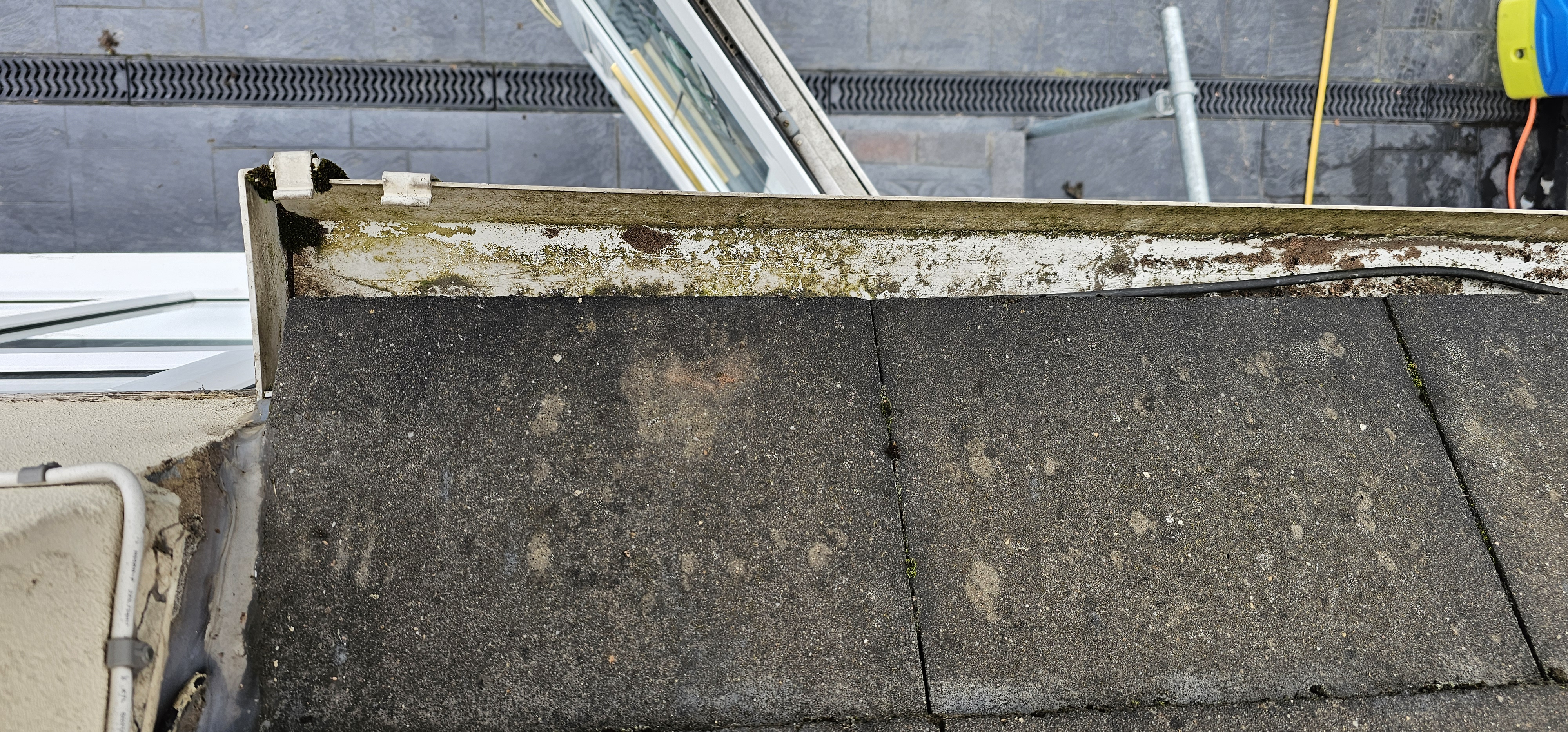 Roofline and dormer window after gutter clearing