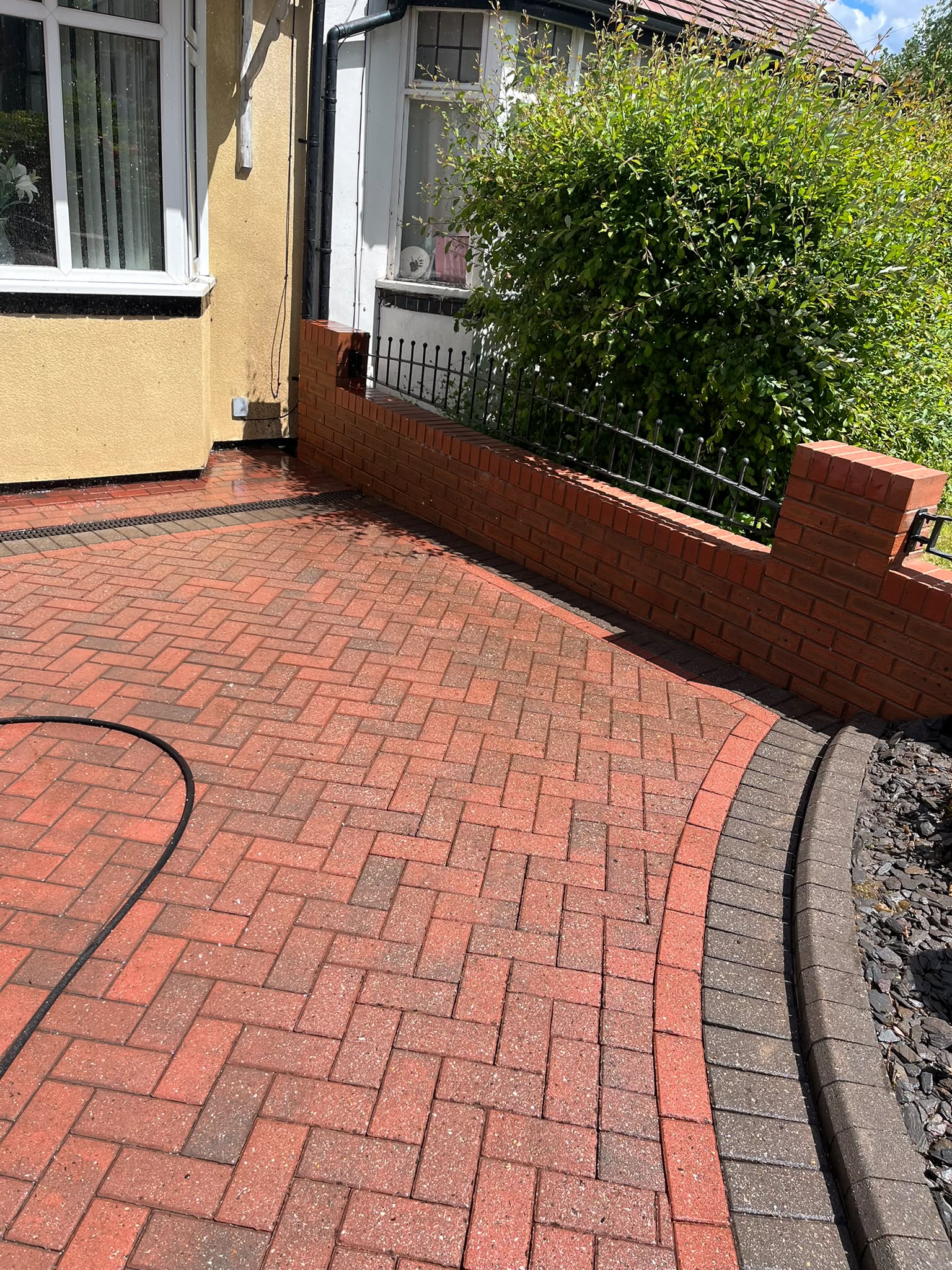 Clean herringbone block-paving driveway after pressure washing