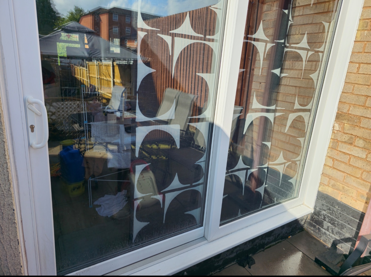Patio door glass with reflections of the garden
